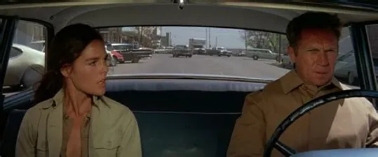 Steve McQueen and Ali McGraw in a car.